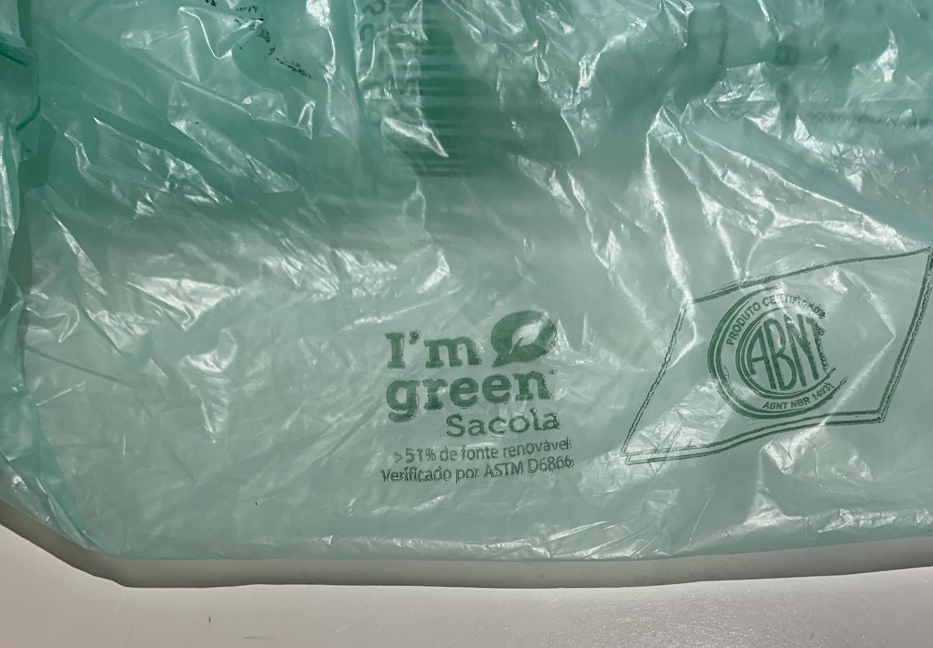 Close-up of a green plastic bag with a icon that says "I'm Green."