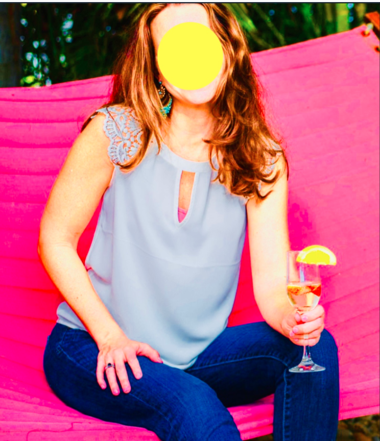 High contrast photo of a white woman drinking a cocktail on a pink hammock, face blocked out by a yellow circle